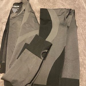 2-piece workout gear. Size XL but fits like a medium. Grey w/ black trim. New.
